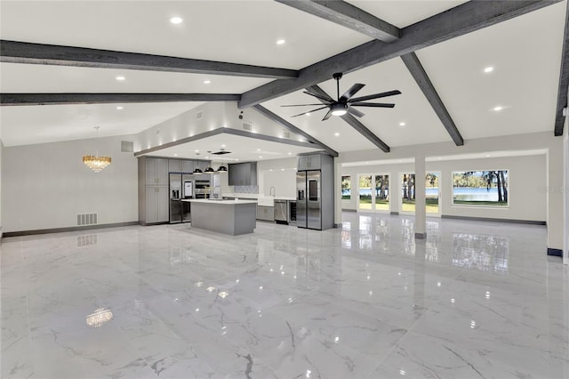 unfurnished living room with ceiling fan with notable chandelier and vaulted ceiling with beams