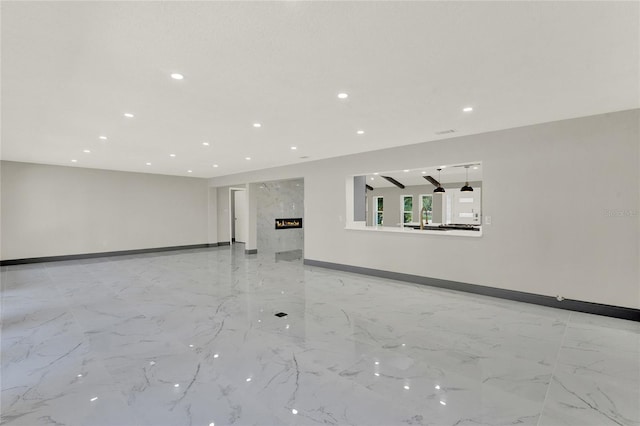 unfurnished living room featuring a fireplace