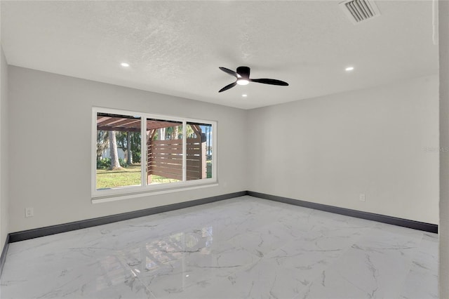 unfurnished room featuring a textured ceiling and ceiling fan