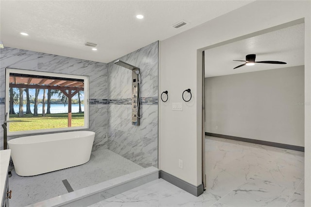 bathroom featuring separate shower and tub, ceiling fan, and a textured ceiling