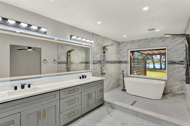 bathroom featuring vanity, ceiling fan, a textured ceiling, and separate shower and tub