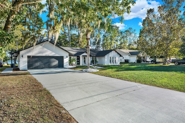 ranch-style home with a front yard and a garage