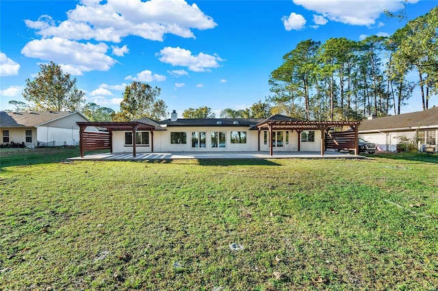 rear view of house featuring a pergola, a patio area, and a yard