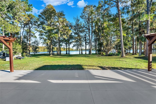 view of home's community with a water view and a yard