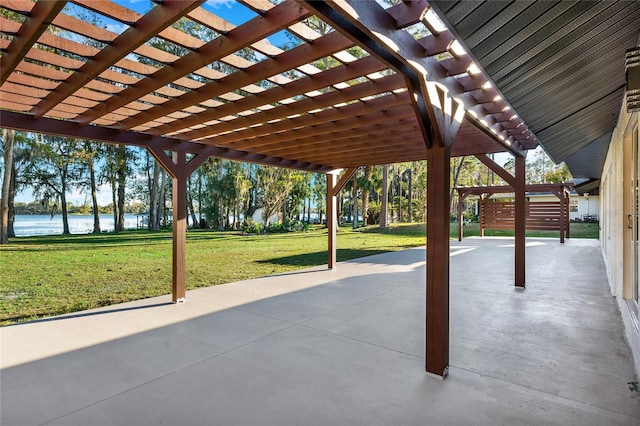 view of patio / terrace featuring a water view and a pergola