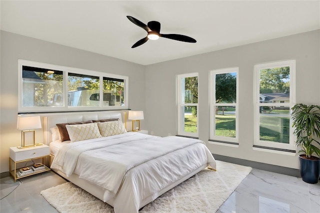 bedroom featuring ceiling fan and multiple windows