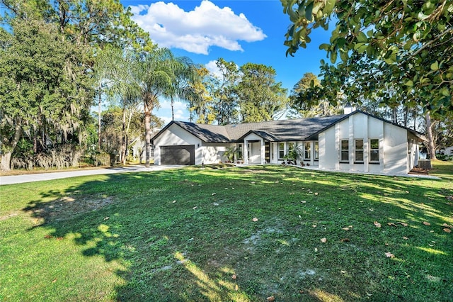 single story home featuring a garage and a front yard