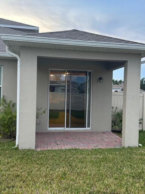 back of house with a patio area and a yard