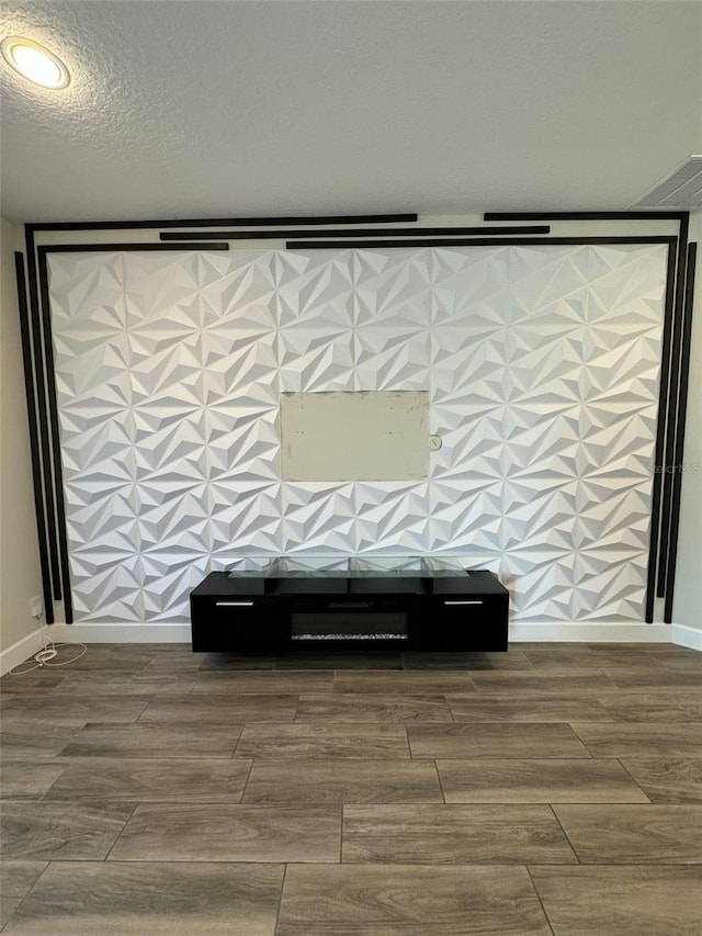 room details featuring wood-type flooring and a textured ceiling