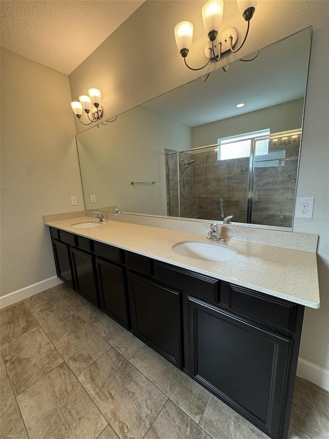 bathroom featuring a textured ceiling, vanity, and walk in shower