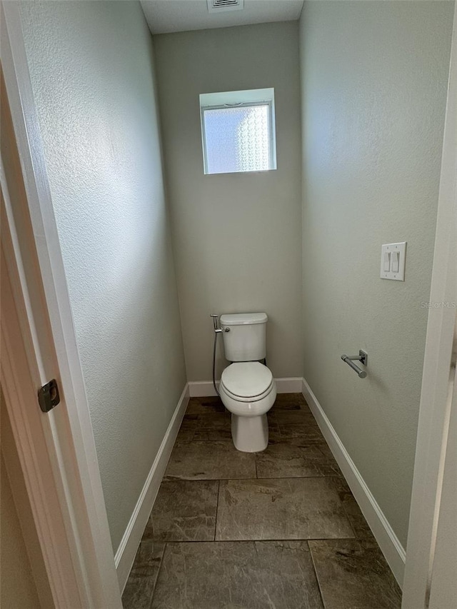 bathroom with tile patterned floors and toilet