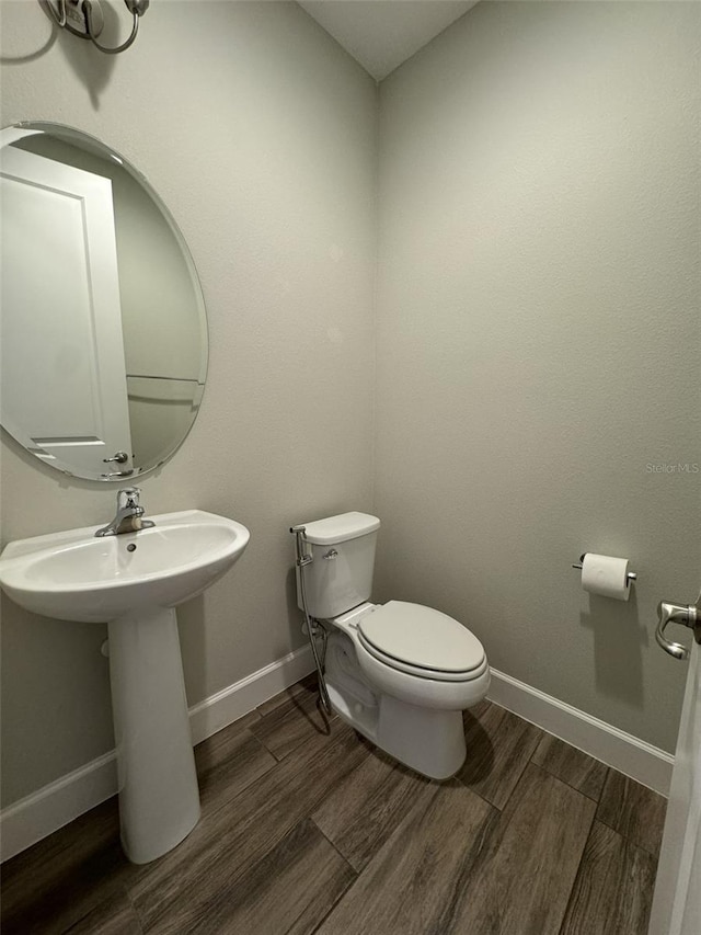 bathroom featuring toilet and hardwood / wood-style flooring