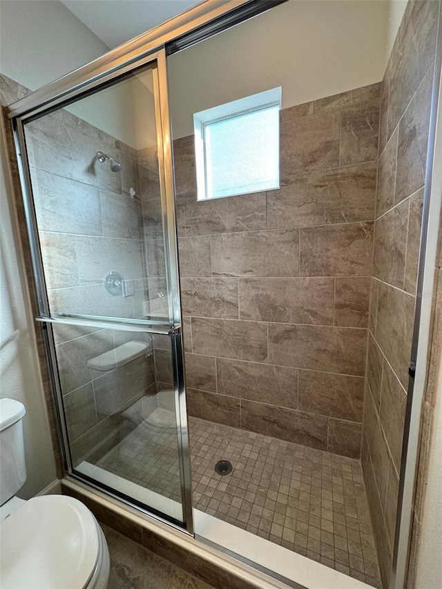 bathroom with toilet and walk in shower