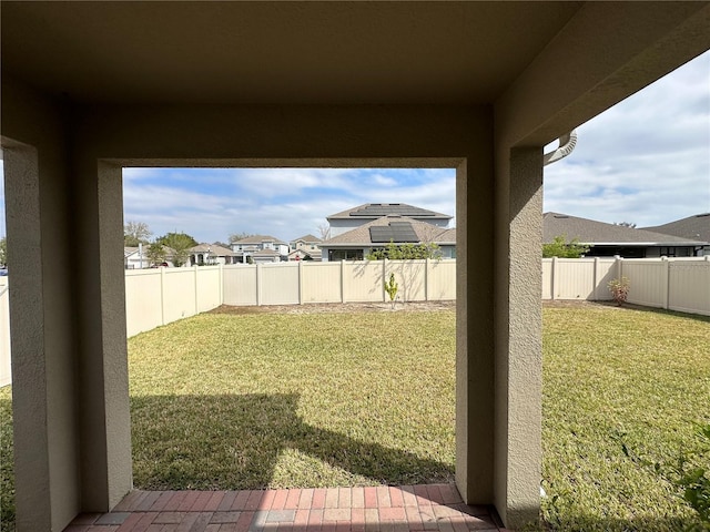 view of yard with a residential view and a fenced backyard