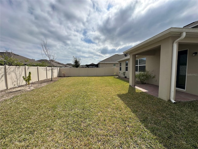 view of yard with a patio and a fenced backyard