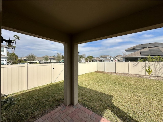 view of yard with a fenced backyard and a residential view