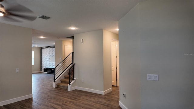 hall with visible vents, baseboards, dark wood finished floors, and stairs