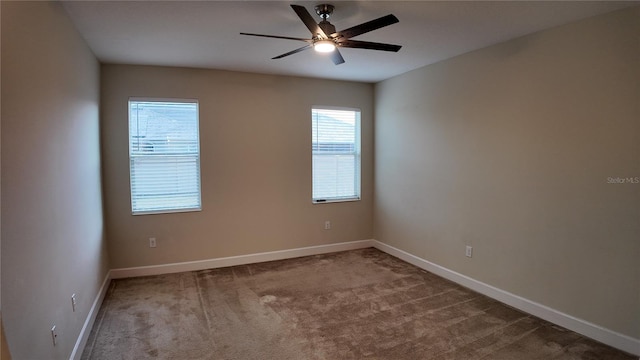 unfurnished room featuring carpet flooring, baseboards, and ceiling fan