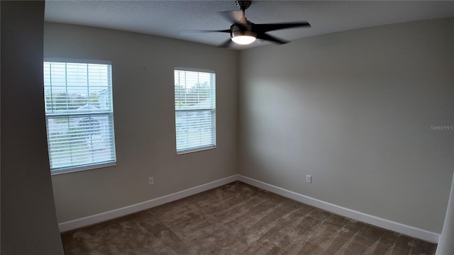 spare room featuring a textured ceiling, a ceiling fan, baseboards, and carpet floors