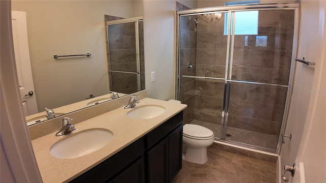 full bathroom featuring a stall shower and a sink