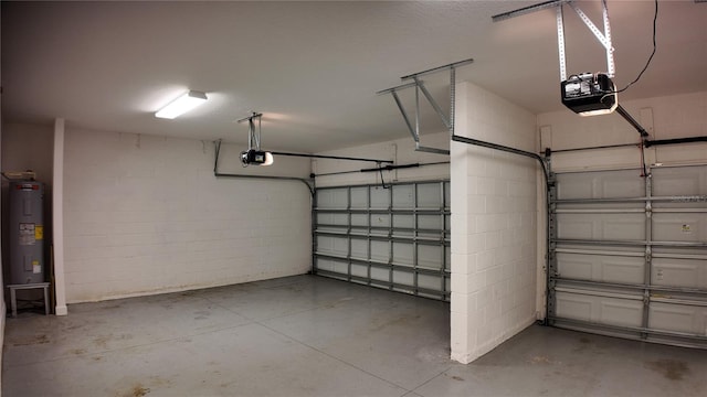 garage featuring concrete block wall, a garage door opener, and electric water heater