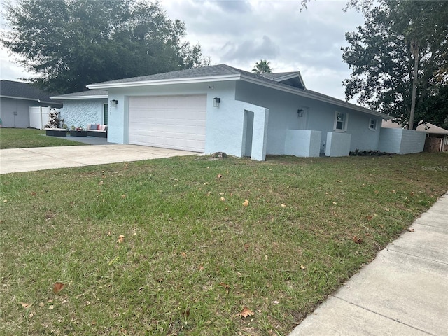 exterior space featuring a garage and a lawn