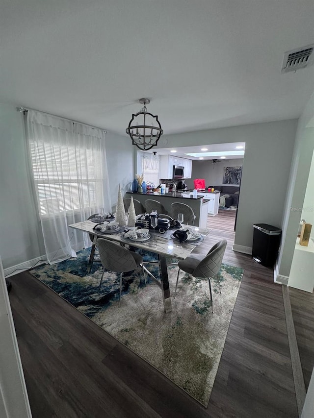 dining space with a chandelier and wood-type flooring