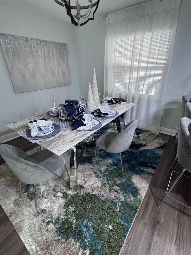 dining space featuring a notable chandelier and dark hardwood / wood-style floors