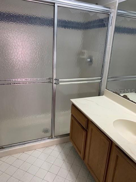 bathroom with vanity, tile patterned floors, and an enclosed shower