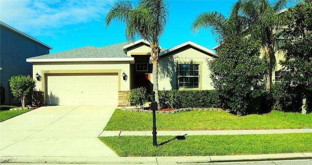 view of front of house with a garage and a front lawn