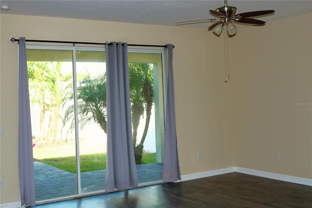 doorway featuring a textured ceiling, dark hardwood / wood-style floors, plenty of natural light, and ceiling fan