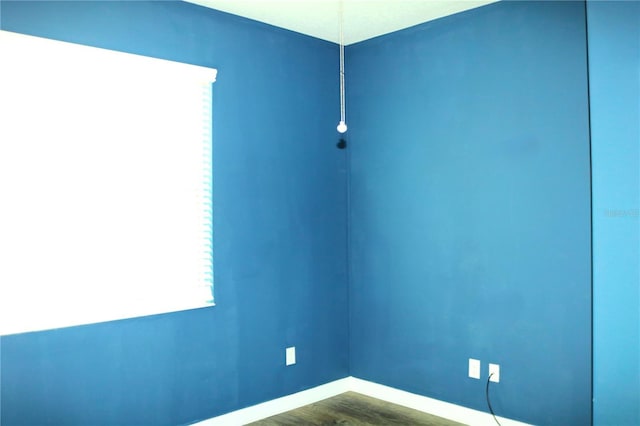 unfurnished room featuring dark wood-type flooring