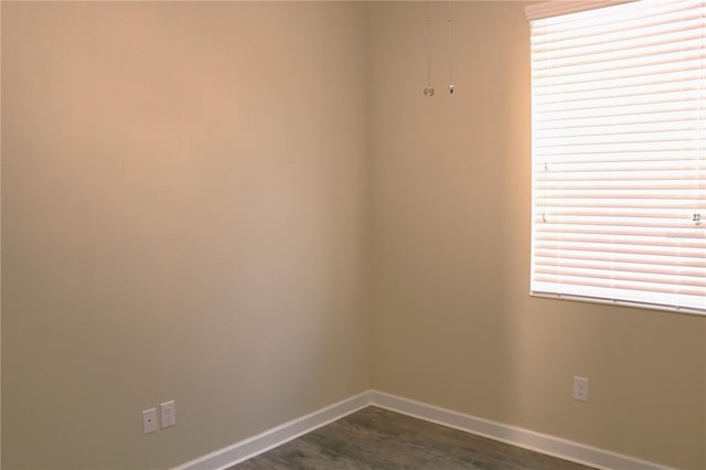 1569 Thetford Cir, Orlando, FL 32824 - spare room with baseboards and dark wood-type flooring