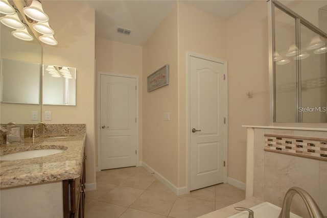 1569 Thetford Cir, Orlando, FL 32824 - bathroom featuring tile patterned flooring, double vanity, a stall shower, and a chandelier