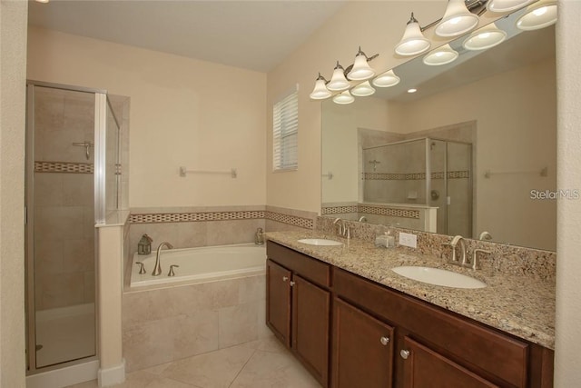 bathroom featuring tile patterned flooring, vanity, and shower with separate bathtub