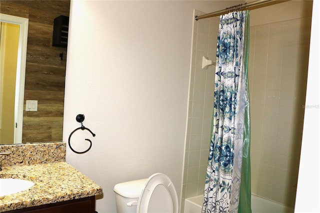 full bathroom featuring shower / bath combo with shower curtain, vanity, toilet, and wooden walls