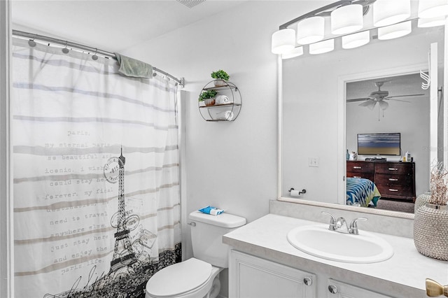 bathroom with a shower with curtain, vanity, toilet, and ceiling fan