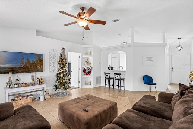 tiled living room with built in shelves, ceiling fan, high vaulted ceiling, and a textured ceiling