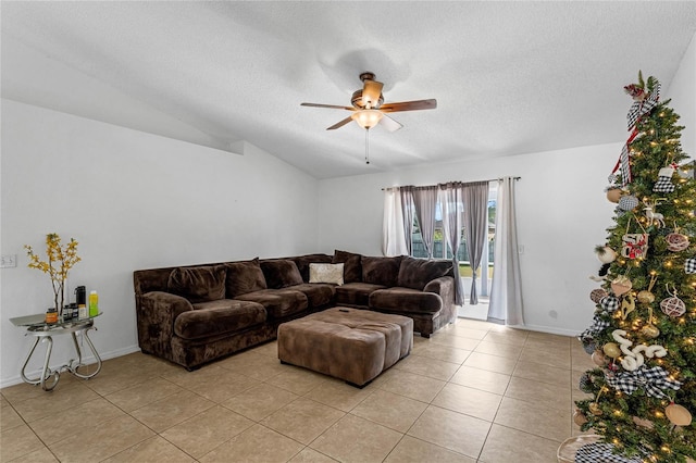 living room featuring ceiling fan, light tile patterned floors, a textured ceiling, and vaulted ceiling