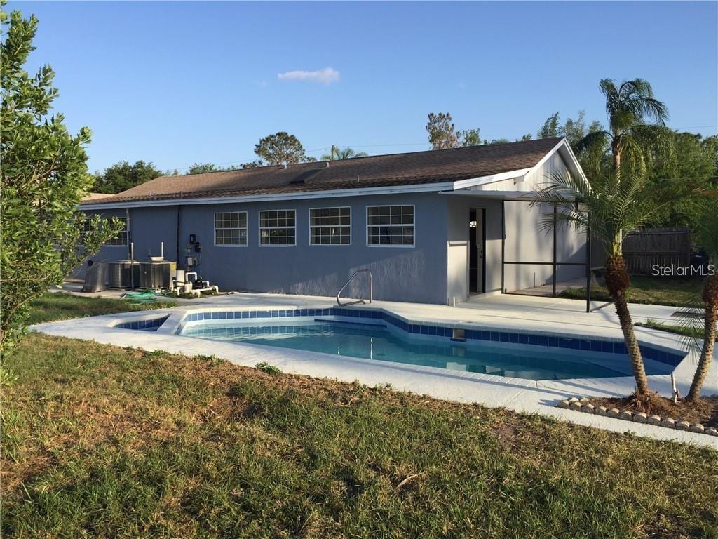 rear view of property with a patio area and a yard