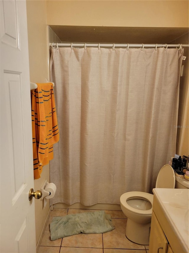 566/568 Imperial Pl, Kissimmee, FL 34758 - bathroom featuring toilet, vanity, tile patterned flooring, and a shower with curtain
