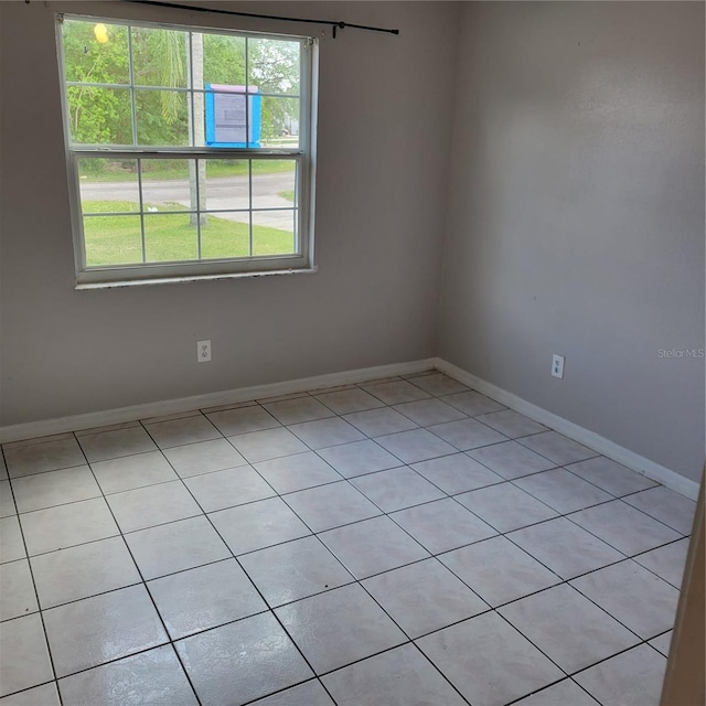566/568 Imperial Pl, Kissimmee, FL 34758 - empty room featuring light tile patterned floors and baseboards