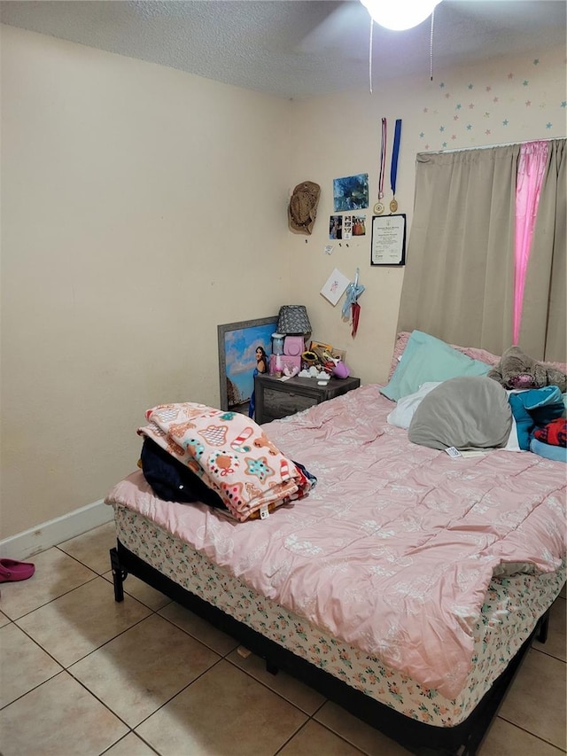 566/568 Imperial Pl, Kissimmee, FL 34758 - tiled bedroom featuring baseboards and ceiling fan