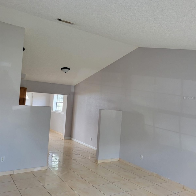 566/568 Imperial Pl, Kissimmee, FL 34758 - spare room with vaulted ceiling and light tile patterned flooring