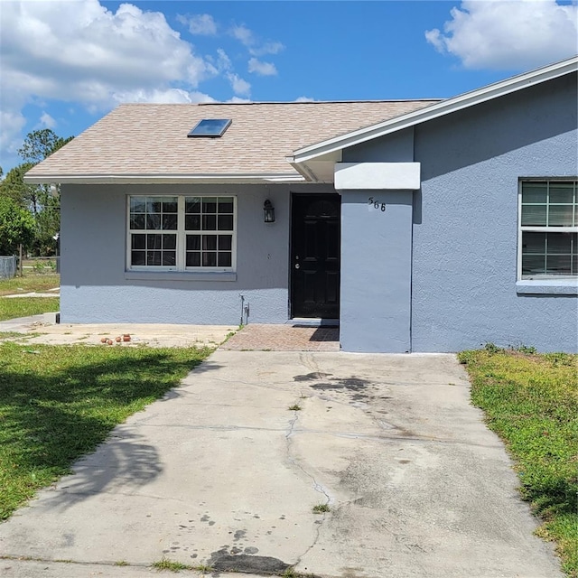 566/568 Imperial Pl, Kissimmee, FL 34758 - view of front of home featuring stucco siding and roof with shingles