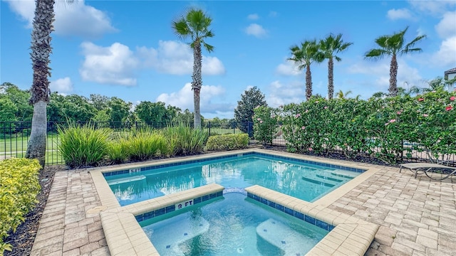 view of pool featuring a patio area and an in ground hot tub