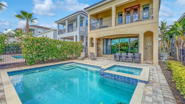 view of pool with an in ground hot tub and a patio