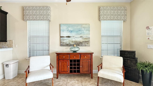 sitting room featuring crown molding, plenty of natural light, and light tile patterned floors