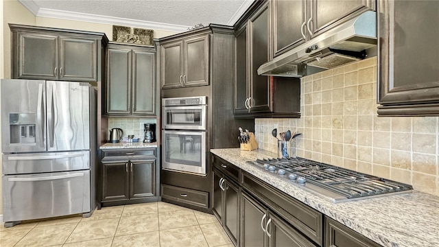 kitchen with tasteful backsplash, light tile patterned floors, ornamental molding, a textured ceiling, and appliances with stainless steel finishes