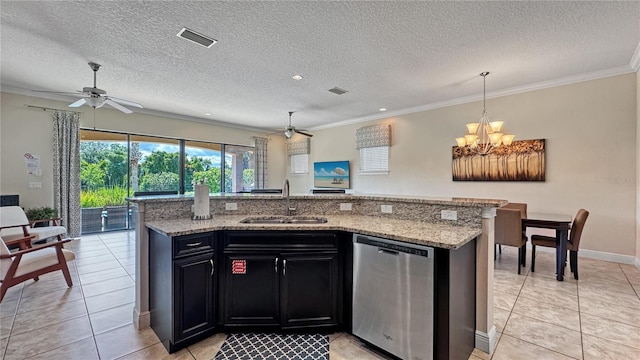 kitchen with a textured ceiling, dishwasher, sink, and an island with sink